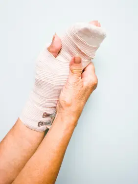Personal-Injury-Cases Injured hand wrapped in sterile gauze bandage for first aid treatment represents personal injury cases